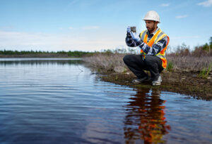 A natural resources employee takes measurements from a protected water source.