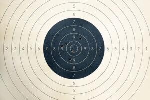 A circular shooting target with rings that are attributed points that increase as they approach the center bullseye.