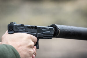 Glock pistol with silencer being held in the shooting position