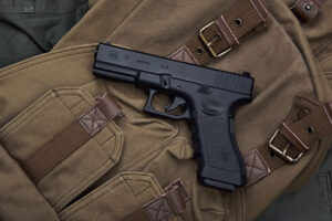 A Glock 17 resting on an ammo bag.