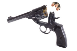 A revolver unhinged to demonstrate the defining movement of a hinge loader.