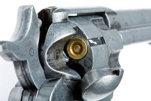 A revolver in a closeup focusing on the loading gate method of loading.