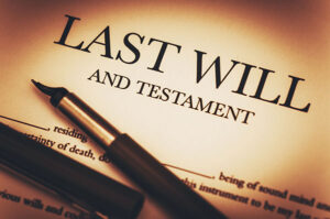 A last will and testament in dramatic lighting with an old school fountain pen.