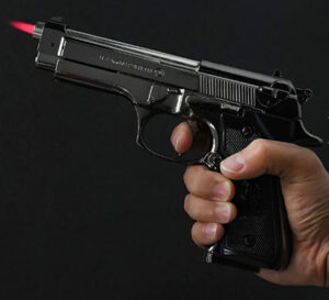 A replica Beretta pistol that is actually a lighter, with a small flame coming out of the barrrel