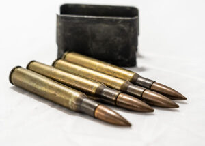 Four full metal jacket bullets resting on their side